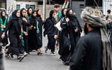 A Taliban security personnel stands guard as Afghan Shiite Muslim women march during a religious procession held to mark Ashura, on the tenth day of the Islamic holy month of Muharram, in Kabul on July 6, 2025. (Photo by Wakil KOHSAR / AFP)