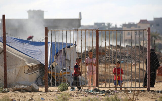 Children stand next to tents at a camp housing displaced Palestinians in the Al-Bureij camp in the central Gaza Strip on July 7, 2025. (Eyad BABA / AFP) Children stand next to tents at a camp housing displaced Palestinians in the Al-Bureij camp in the central Gaza Strip on July 7, 2025. (Eyad BABA / AFP)
