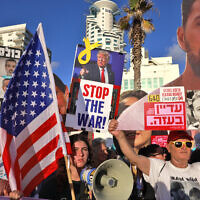 Activists hold portraits of Israeli hostages held in the Gaza Strip by Hamas during a protest calling for their release and an end to the war, outside the the branch office of the US embassy in Tel Aviv on July 7, 2025. (Menahem Kahana / AFP)