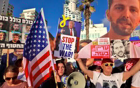 Activists hold portraits of Israeli hostages held in the Gaza Strip by Hamas during a protest calling for their release and an end to the war, outside the the branch office of the US embassy in Tel Aviv on July 7, 2025.  (Menahem Kahana / AFP)