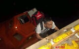 This handout picture provided by the UAE Ministry of Foreign Affairs reportedly shows members of the Greek-owned, Liberian-flagged Magic Seas commercial vessel climbing on board the Safeen Prism, after being rescued following a Houthi attack that forced them to abandon ship, in the Red Sea on July 6, 2025. (UAE's Ministry of Foreign Affairs and International Cooperation / AFP)