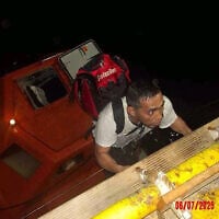 This handout picture provided by the UAE Ministry of Foreign Affairs reportedly shows members of the Greek-owned, Liberian-flagged Magic Seas commercial vessel climbing on board the Safeen Prism, after being rescued following a Houthi attack that forced them to abandon ship, in the Red Sea on July 6, 2025. (UAE's Ministry of Foreign Affairs and International Cooperation / AFP)