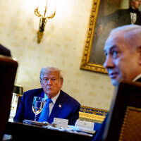 Prime Minister Benjamin Netanyahu, right, speaks as US President Donald Trump looks on during a dinner in the Blue Room of the White House in Washington, July 7, 2025. (Andrew Harnik/Getty Images/AFP)