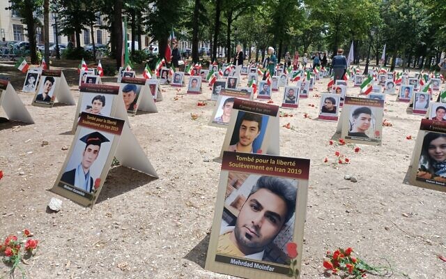 Portraits of slain Iranians are displayed in  Paris on July 8, 2025, as part of a campaign led by Comité Iran Liberte and Comité de Soutien aux droits de l'homme en Iran (CSDHI) to stop executions in the Islamic Republic. (Delphine Touitou / AFP)