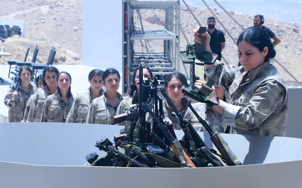 Kurdish PKK fighters burn their weapons at disarmament ceremony in Iraq