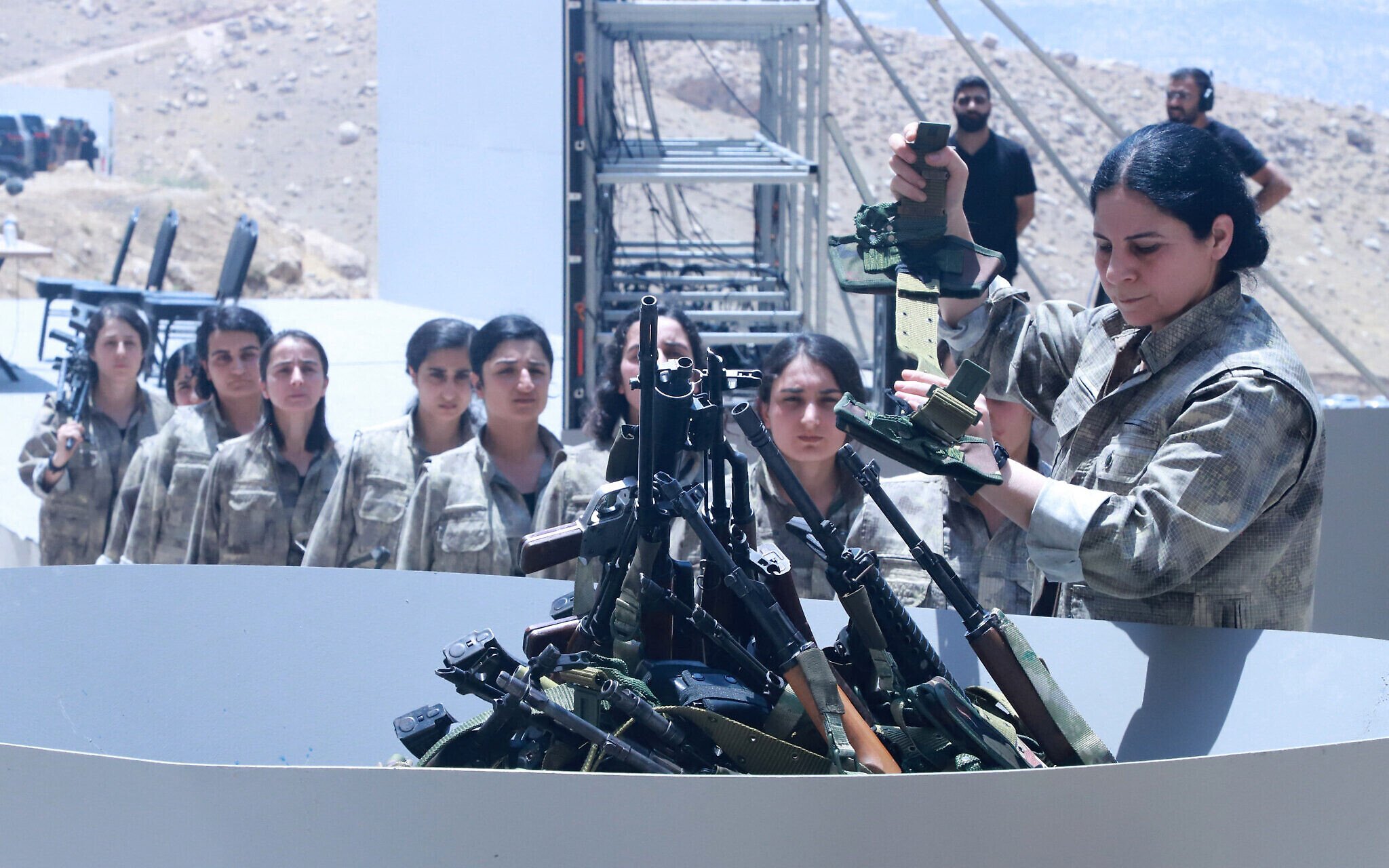 Kurdish PKK fighters burn their weapons at disarmament ceremony in Iraq
