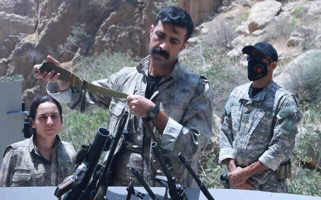 A fighter with the Kurdistan Workers' Party (PKK) puts his weapon into a pit during a ceremony in Sulaimaniyah, in Iraq's autonomous Kurdistan region, on July 11, 2025. (Shwan MOHAMMED / AFP) A fighter with the Kurdistan Workers' Party (PKK) puts his weapon into a pit during a ceremony in Sulaimaniyah, in Iraq's autonomous Kurdistan region, on July 11, 2025. (Shwan MOHAMMED / AFP)