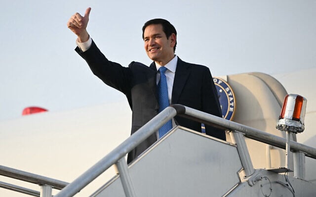 US Secretary of State Marco Rubio gestures as he boards his flight before departing from Subang Air Base, on the outskirts of Kuala Lumpur, on July 11, 2025. (Mandel NGAN / POOL / AFP)