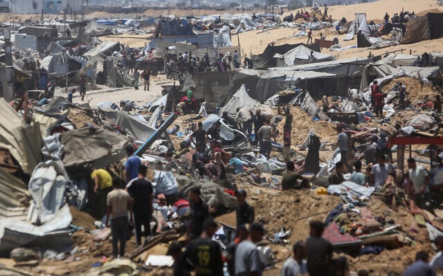 Palestinians inspect the destruction at a makeshift displacement camp following a reported incursion a day earlier by Israeli tanks in the area in Khan Younis in the northern Gaza strip on July 11, 2025. (AFP)