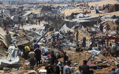 Palestinians inspect the destruction at a makeshift displacement camp following a reported incursion a day earlier by Israeli tanks in the area in Khan Younis, in the southern Gaza Strip, on July 11, 2025. (AFP) Palestinians inspect the destruction at a makeshift displacement camp following a reported incursion a day earlier by Israeli tanks in the area in Khan Younis, in the southern Gaza Strip, on July 11, 2025. (AFP)