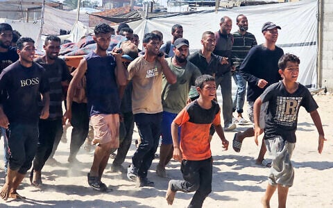 Palestinians transport a victim to a Red Cross clinic in Rafah in the southern Gaza Strip after he was reportedly shot as he waited to receive food parcels at a distribution point run by the US and Israel-backed Gaza Humanitarian Foundation, on July 12, 2025. (AFP)