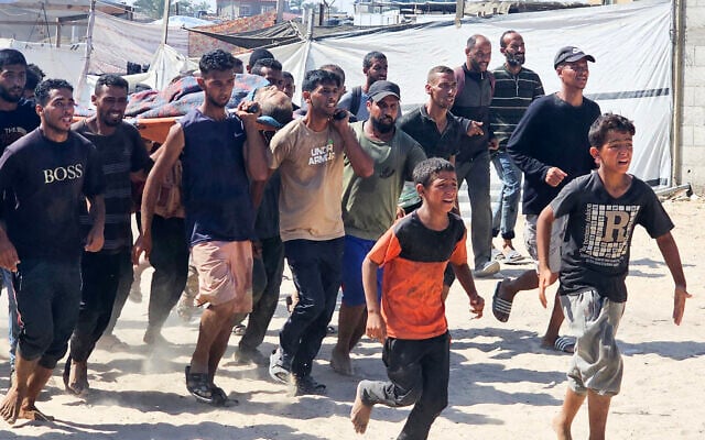 Palestinians transport a victim to a Red Cross clinic in Rafah in the southern Gaza Strip after he was reportedly shot as he waited to receive food parcels at a distribution point run by the US and Israel-backed Gaza Humanitarian Foundation, on July 12, 2025. (AFP) Palestinians transport a victim to a Red Cross clinic in Rafah in the southern Gaza Strip after he was reportedly shot as he waited to receive food parcels at a distribution point run by the US and Israel-backed Gaza Humanitarian Foundation, on July 12, 2025. (AFP)