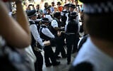 A protester is carried away after being arrested as people gather in support of the anti-Israel group "Palestine Action", in Parliament Square, London on July 12, 2025. (Justin Tallis/AFP)