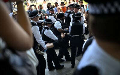 A protester is carried away after being arrested as people gather in support of the anti-Israel group "Palestine Action", in Parliament Square, London on July 12, 2025. (Justin Tallis/AFP)