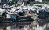 Encampments sheltering Palestinians displaced by conflict are pitched near the Sheikh Radwan wastewater collection pond, which is nearing its filling capacity, in Gaza City on July 14, 2025. (Bashar TALEB / AFP)