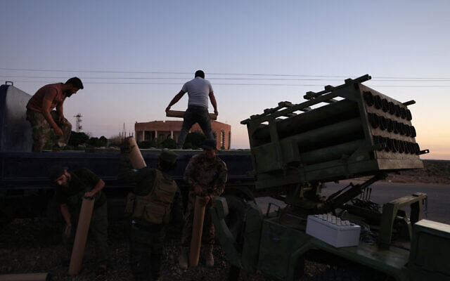 Members of Syria's security forces load a rocket in an area between Mazraa and Walga near the predominantly Druze city of Sweida on July 14, 2025, following clashes between Bedouin tribes and Druze fighters. (Bakr ALKASEM / AFP)