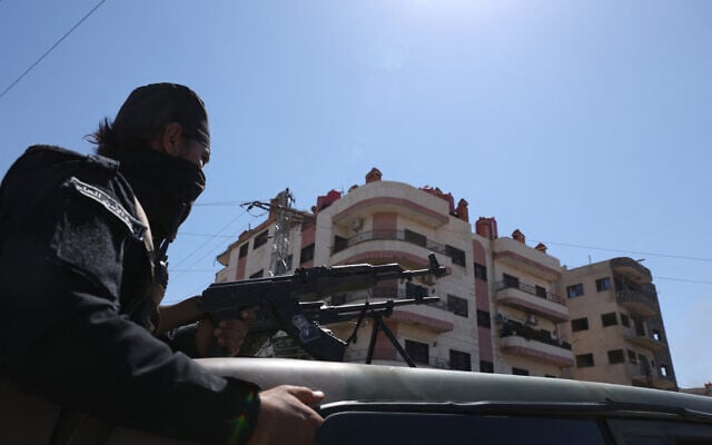 A member of Syria's security forces sits atop a military vehicle as security forces enter the predominantly Druze city of Sweida on July 15, 2025(Photo by Bakr ALkasem / AFP)