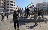 Syria's security forces pose for a picture on a roundabout in the predominantly Druze city of Sweida on July 15, 2025, following clashes between Bedouin tribes and Druze fighters. (Sam HARIRI / AFP)