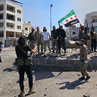 Syria's security forces pose for a picture on a roundabout in the predominantly Druze city of Sweida on July 15, 2025, following clashes between Bedouin tribes and Druze fighters. (Sam HARIRI / AFP)