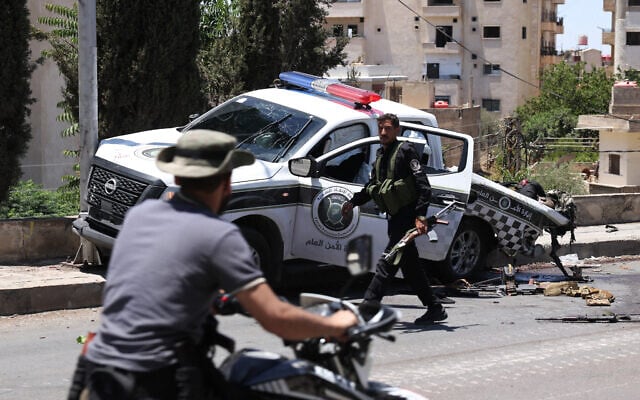 The body of a member of Syria's security forces lies in a damaged pickup truck following an Israeli strike in the predominantly Druze city of Sweida on July 15, 2025, following clashes between Bedouin tribes and Druze fighters. (Photo by Bakr ALKASEM / AFP) The body of a member of Syria's security forces lies in a damaged pickup truck following an Israeli strike in the predominantly Druze city of Sweida on July 15, 2025, following clashes between Bedouin tribes and Druze fighters. (Photo by Bakr ALKASEM / AFP)