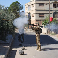 A Syrian security force member fires a shoulder-launched weapon amid clashes in the southern Sweida city on July 16, 2025.  (Photo by OMAR HAJ KADOUR / AFP)