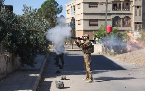 A Syrian security force member fires a shoulder-launched weapon amid clashes in the southern Sweida city on July 16, 2025.  (Photo by OMAR HAJ KADOUR / AFP)