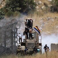 Israeli troops use tear gas to disperse the crowds as Druze attempt to cross the Syrian border on the Golan Heights near Majdal Shams on July 16, 2025 (Jalaa MAREY / AFP)