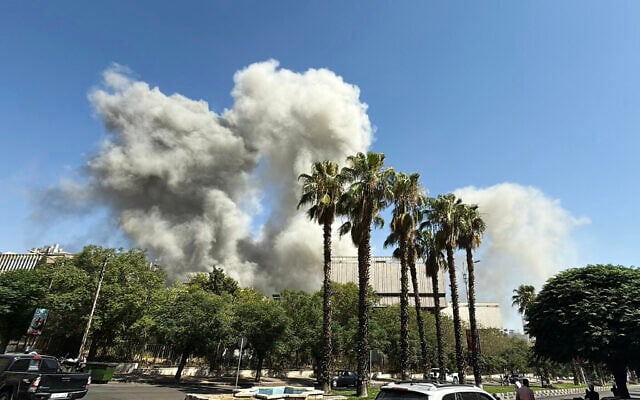 Smoke billows following Israeli strikes near the Syrian army and defense ministry headquarters in Damascus on July 16, 2025. (Rami al SAYED / AFP)