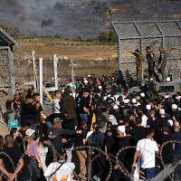 Members of Israel's Druze community attempt to enter Syria through the buffer zone between Syria and the Israeli Golan Heights near Majdal Shams on July 16, 2025, amid deadly sectarian violence in southern Syria. (Jalaa Marey/AFP)