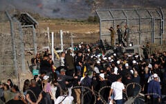 Members of Israel's Druze community attempt to enter Syria through the buffer zone between Syria and the Israeli Golan Heights near Majdal Shams on July 16, 2025, amid deadly sectarian violence in southern Syria. (Jalaa Marey/AFP)