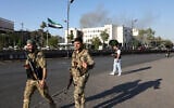 Syrian security forces stand guard in front of the heavily damaged Syrian army and defense ministry headquarters complex in Damascus, following Israeli strikes on July 16, 2025. (Bakr Alkasem/AFP)