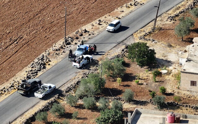An aerial picture shows a view of Druze gunmen deploying in al-Dur village in Syria's southern Sweida governorate on July 17, 2025. (Omar HAJ KADOUR / AFP)