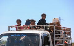 Bedouin residents leave in trucks loaded with their belongings, in the vicinity of the Druze al-Mazraa village in Syria's southern Sweida governorate on July 17, 2025, seeking safer areas amid ongoing clashes. (Bakr ALKASEM / AFP)