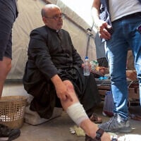 Parish Priest of the Holy Family church in Gaza City Fr. Gabriel Romanelli receives care after he was injured in an Israeli strike on the church, at the city's Arab Ahli, also known as Baptist, hospital on July 17, 2025. (Omar AL-QATTAA / AFP)