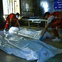 Red Crescent rescuers lay down bodies of victims of the recent clashes between local Druze fighters and Bedouin tribes, inside a hospital in Syria's southern city of Sweida on July 17, 2025. (Shadi al-Dubaisi/AFP)
