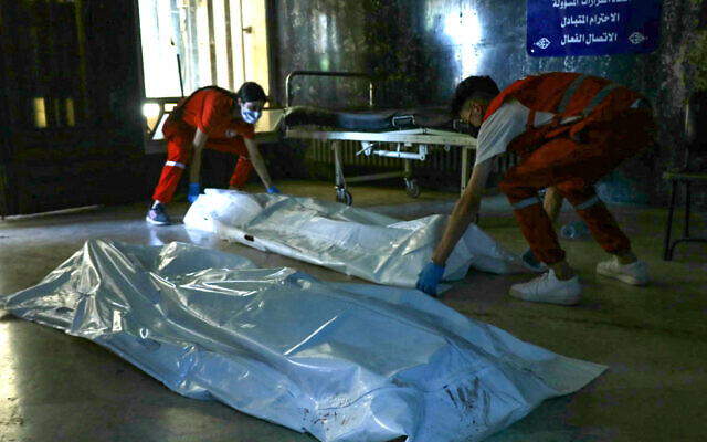 Red Crescent rescuers lay down bodies of victims of the recent clashes between local Druze fighters and Bedouin tribes, inside a hospital in Syria's southern city of Sweida on July 17, 2025. (Shadi al-Dubaisi/AFP) Red Crescent rescuers lay down bodies of victims of the recent clashes between local Druze fighters and Bedouin tribes, inside a hospital in Syria's southern city of Sweida on July 17, 2025. (Shadi al-Dubaisi/AFP)