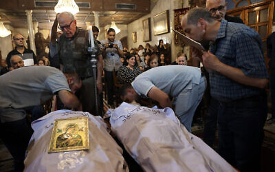 Christian Palestinian mourners bid farewell to Saad Salameh and Foumia Ayyad, killed earlier by errant Israeli tank fire that hit the Holy Family church in Gaza City, during their funeral ceremony at the Saint Porphyrius Church on July 17, 2025. (Omar al-Qattaa/AFP)