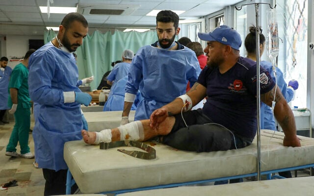 A wounded man receives treatment at a hospital in Syria's southern city of Sweida on July 18, 2025. (Shadi AL-DUBAISI / AFP)