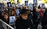 People hold pictures of victims during a ceremony to commemorate the 31st anniversary the AMIA bombing attack which left 85 dead and more than 300 wounded, in Buenos Aires, Argentina, on July 18, 2025. (Luis ROBAYO / AFP)