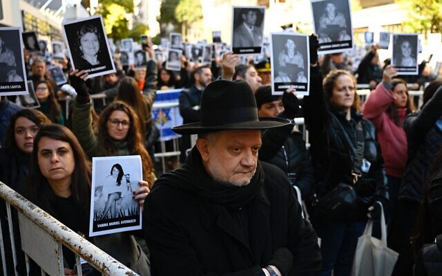 People hold pictures of victims during a ceremony to commemorate the 31st anniversary the AMIA bombing attack which left 85 dead and more than 300 wounded, in Buenos Aires, Argentina, on July 18, 2025. (Luis ROBAYO / AFP) People hold pictures of victims during a ceremony to commemorate the 31st anniversary the AMIA bombing attack which left 85 dead and more than 300 wounded, in Buenos Aires, Argentina, on July 18, 2025. (Luis ROBAYO / AFP)