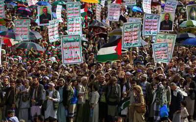 Yemenis lift placards and Palestinian flags during a rally against Israel and the United States, in the Houthi-run capital Sanaa on July 18, 2025. (Mohammed Huwais/AFP)