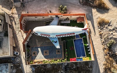 This aerial view shows a guesthouse built in the shape of an airplane in the Palestinian town of Qaffin, in the northwestern part of the West Bank, on July 2, 2025. (John WESSELS / AFP)