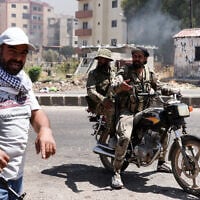 Bedouin and tribal fighters gather in the streets of the city of Sweida in southern Syria's Druze majority province on July 19, 2025. (Bakr Alkasem/AFP)