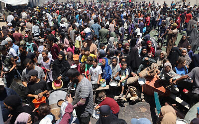 Illustrative: Palestinians gather at a food distribution point in the Nuseirat refugee camp in the central Gaza Strip on July 19, 2025 (Eyad BABA / AFP)