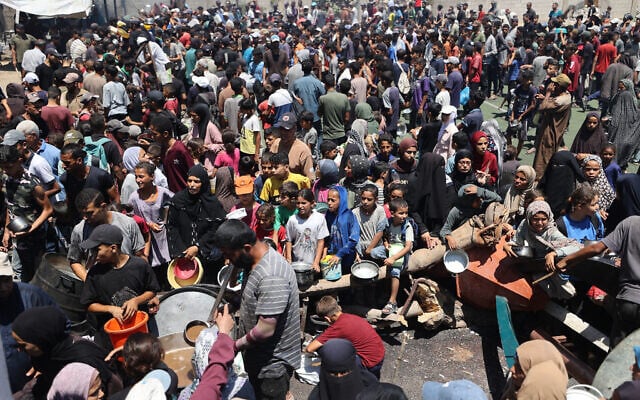 Illustrative: Palestinians gather at a food distribution point in the Nuseirat refugee camp in the central Gaza Strip on July 19, 2025 (Eyad BABA / AFP)