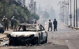 Bedouin tribal gunmen walk in a neighborhood in Sweida in Syria's southern province, despite an announcement by the Syrian interim president of an immediate ceasefire on July 19, 2025 (Bakr ALKASEM / AFP)
