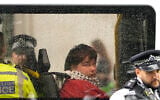 A protester is seen in a police van after being detained during a demonstration calling for the ban on Palestine Action, proscribed under anti-terrorism laws, to be lifted, in Parliament Square, central London, on July 19, 2025. (CARLOS JASSO / AFP)