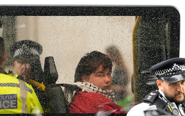 A protester is seen in a police van after being detained during a demonstration calling for the ban on Palestine Action, proscribed under anti-terrorism laws, to be lifted, in Parliament Square, central London, on July 19, 2025. (CARLOS JASSO / AFP)
