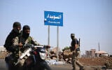 Tribal and Bedouin fighters deploy in the western neighborhood of southern Syria's predominantly Druze city of Sweida, amid clashes with Druze fighters on July 19, 2025. (Abdulaziz Ketaz/AFP)