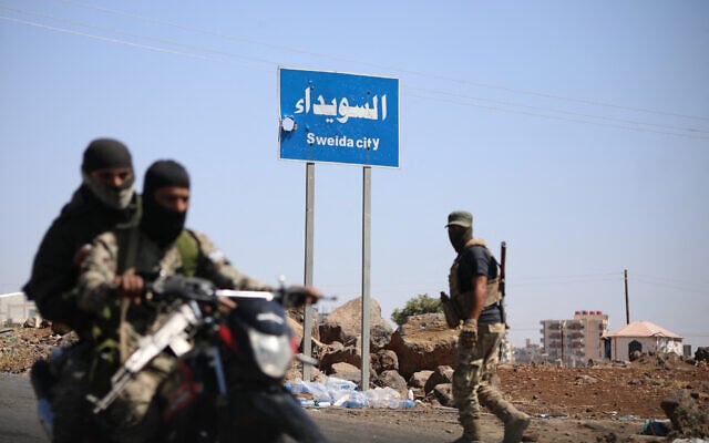 Tribal and Bedouin fighters deploy in the western neighborhood of southern Syria's predominantly Druze city of Sweida, amid clashes with Druze fighters on July 19, 2025. (Abdulaziz Ketaz/AFP)